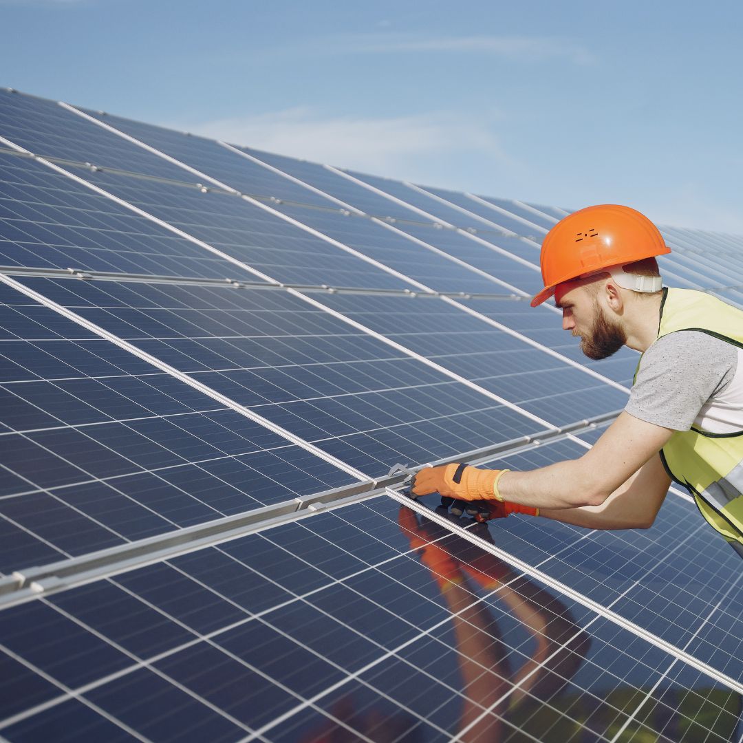 worker installing solar panels