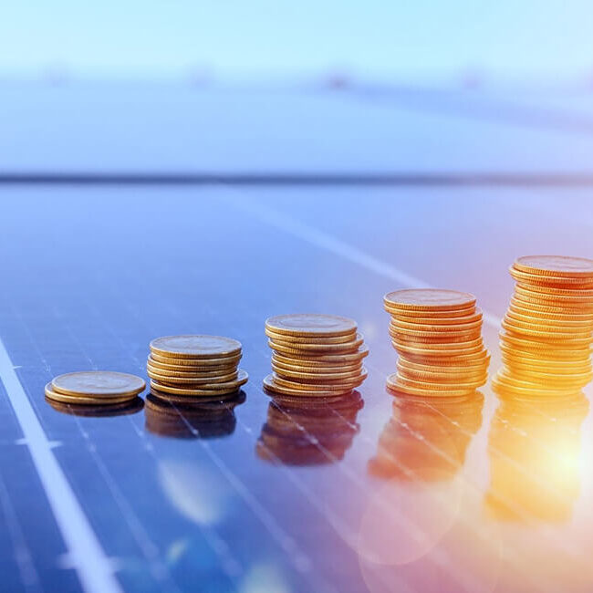 coins stacked on solar panel