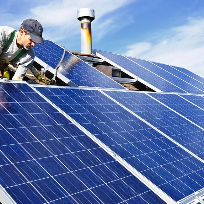 a professional installing solar panels on a home