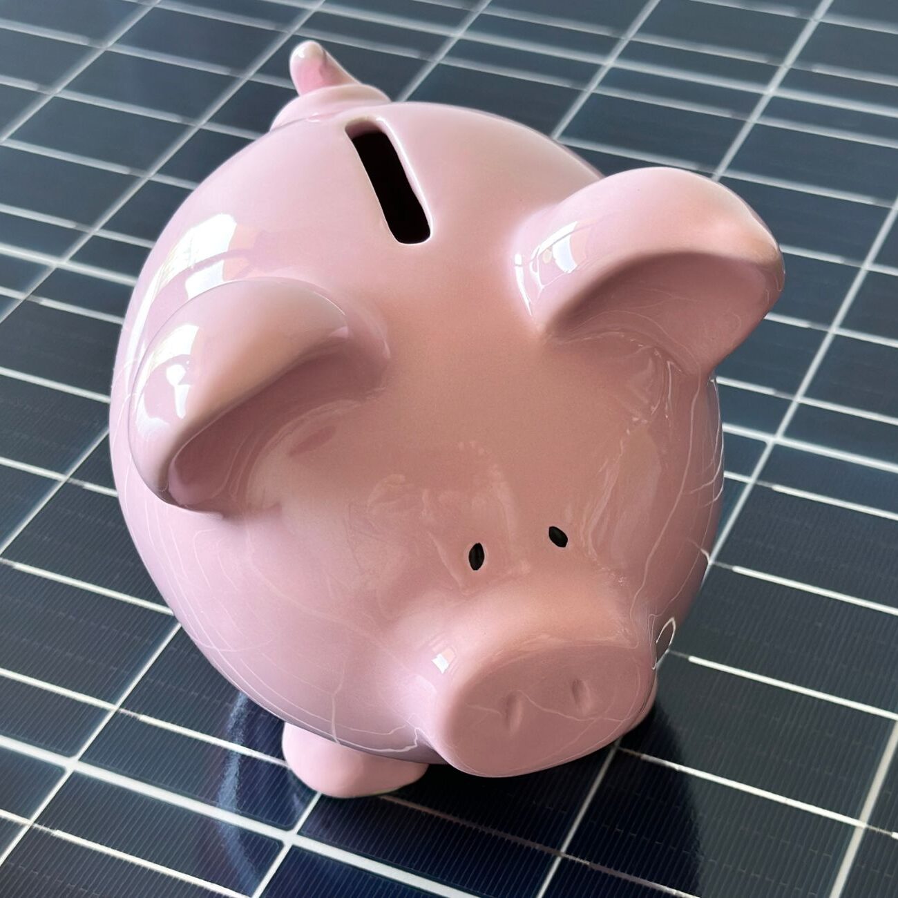 piggy bank on top of a solar panel